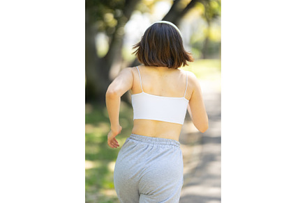 A woman is running in a park