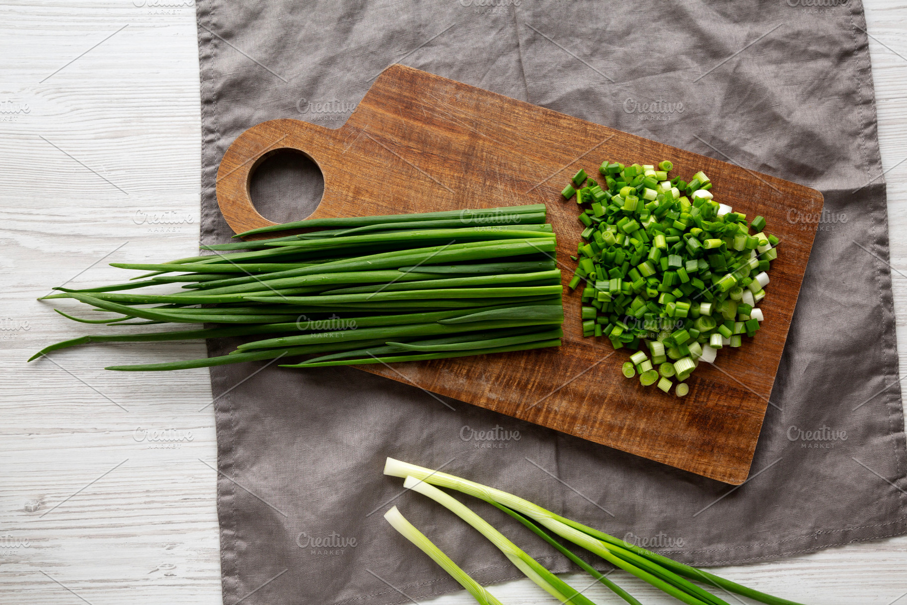Organic Cut Green Onion Scallions on a Wooden Board, top view., a Food & Drink Photo by LiudmylaChuhunova