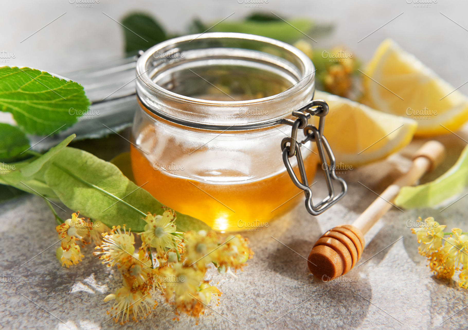 Honey jar with linden flowers and lemon, a Food & Drink Photo by Olena Rudo