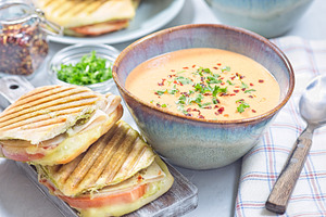 Red bell pepper cream soup served with grilled turkey panini, horizontal, a Food & Drink Photo by iuliia_n