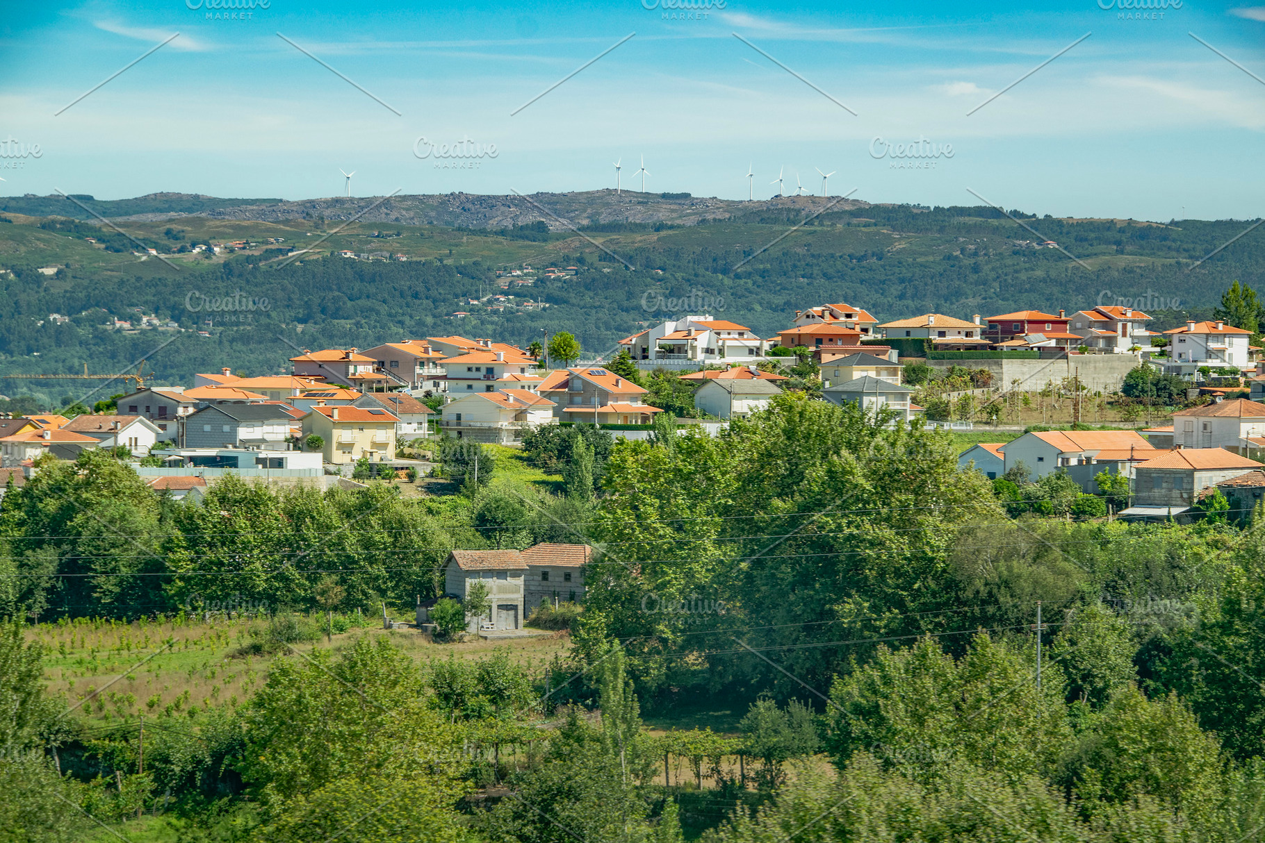Mountain village with clustered homes among trees, an Architecture Photo by DanFLCreativo