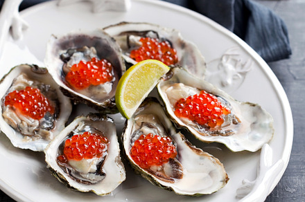 Fresh oysters, garnished with red ca