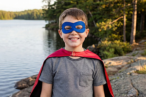 Young Boy in Superhero Cape and Mask, a Person Photo by Virgo Studio