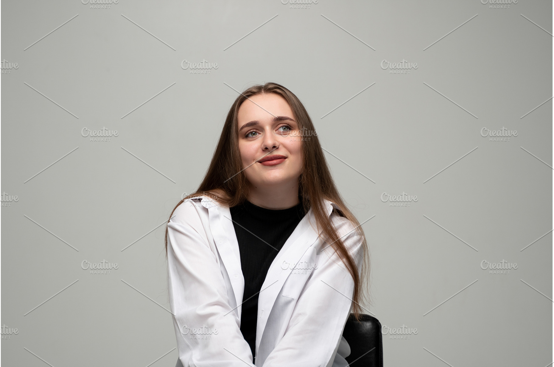 Young woman daydreaming smiling, a Person Photo by volodymyrshtun13795