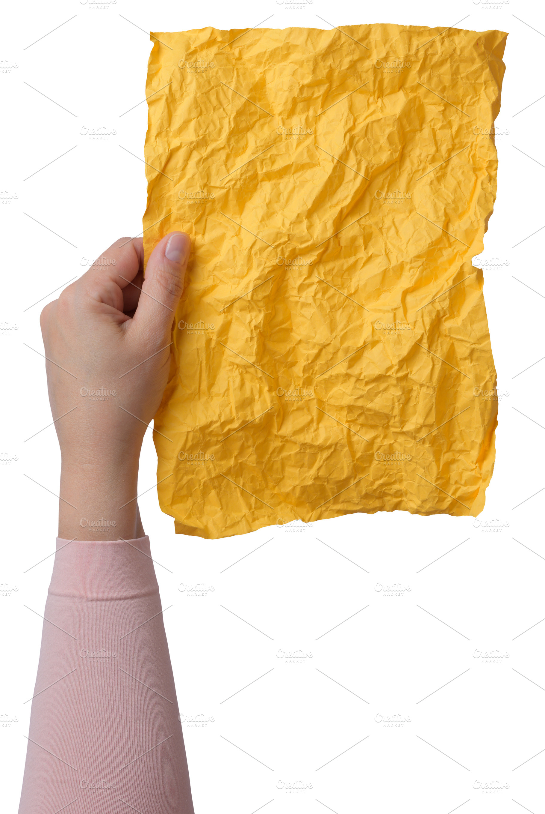A woman's hand holds a vertical sheet of crumpled yellow paper,, a Person Photo by ndanko