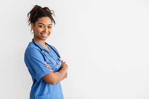 Portrait of black doctor looking at camera with folded arms, a Photo by Prostock-Studio