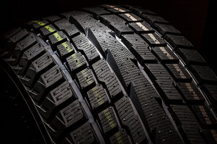 SUV winter tyre on black background,