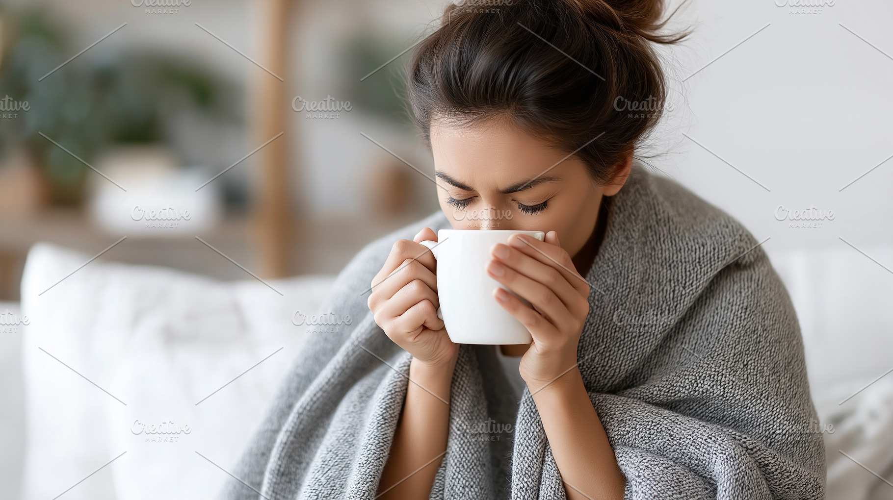 Woman wrapped in a grey blanket sits, a Health & Medical Photo by MistyDay