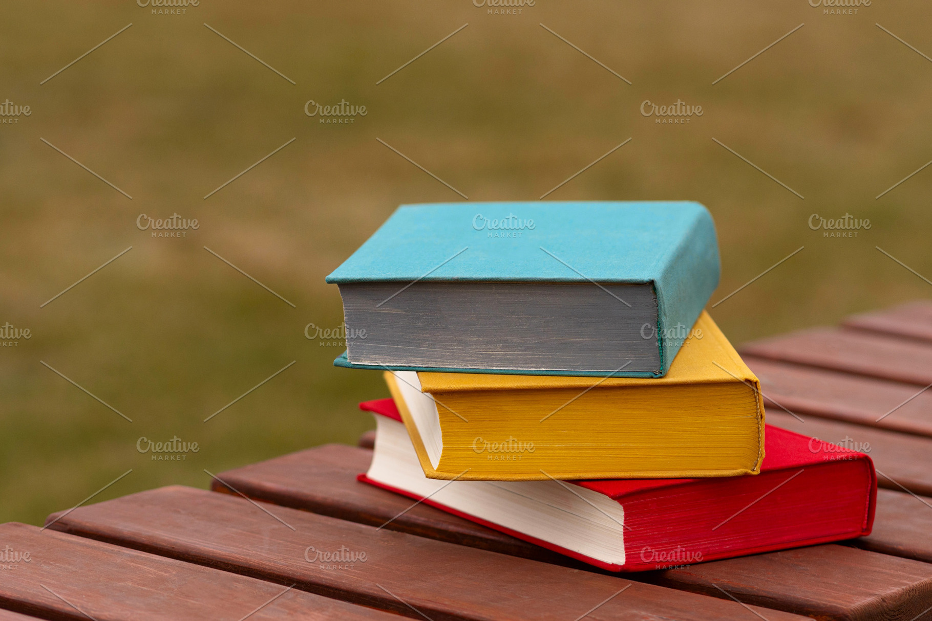 Colorful hardcover books stacked, a Person Photo by Elena Vagengeim