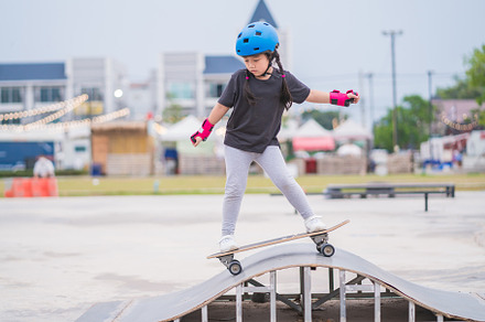 Child or kid girl playing surfskate or skateboard in skating rin, a Sports & Recreation Photo by Casanowe-studio