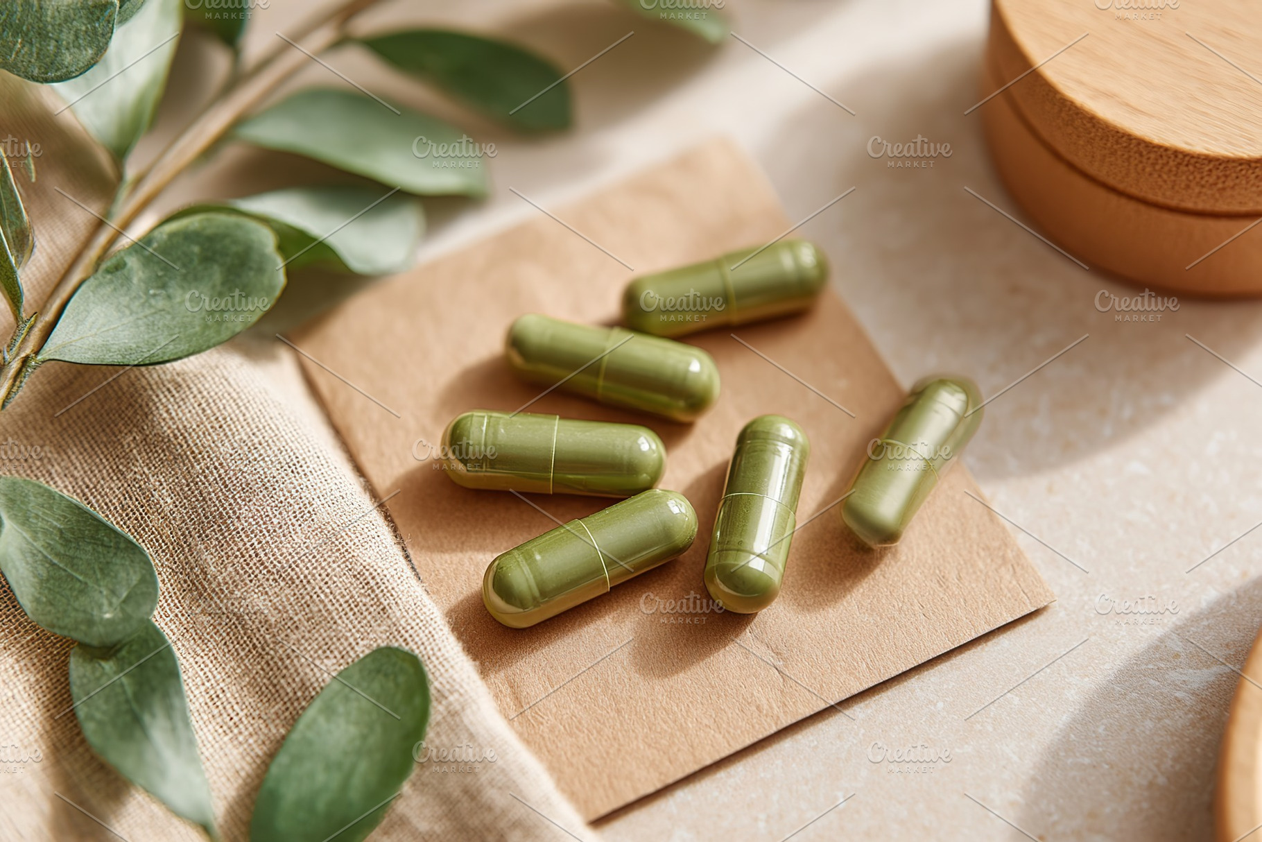 Green capsules on a natural background with leaves and wooden elements showcasi, a Health & Medical Photo by AlyaAnd