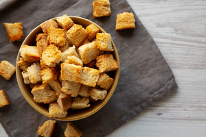 Homemade Crispy Bread Croutons in a Bowl, top view. Close-up., a Food & Drink Photo by LiudmylaChuhunova