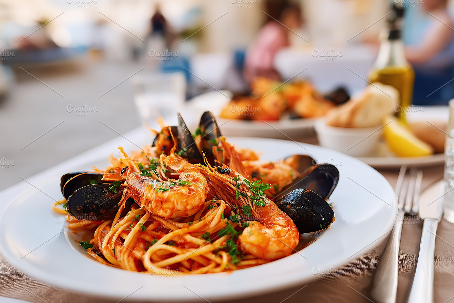 Delicious linguine pasta with tomato sauce and seafood served on a sunny terrac, a Food & Drink Photo by AlyaAnd