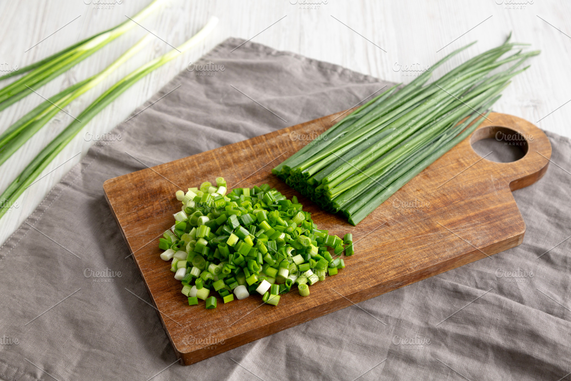 Organic Cut Green Onion Scallions on a Wooden Board, side view., a Food & Drink Photo by LiudmylaChuhunova