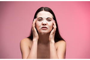 Woman applying hydrating sheet face, a Health & Medical Photo by volodymyrshtun13795
