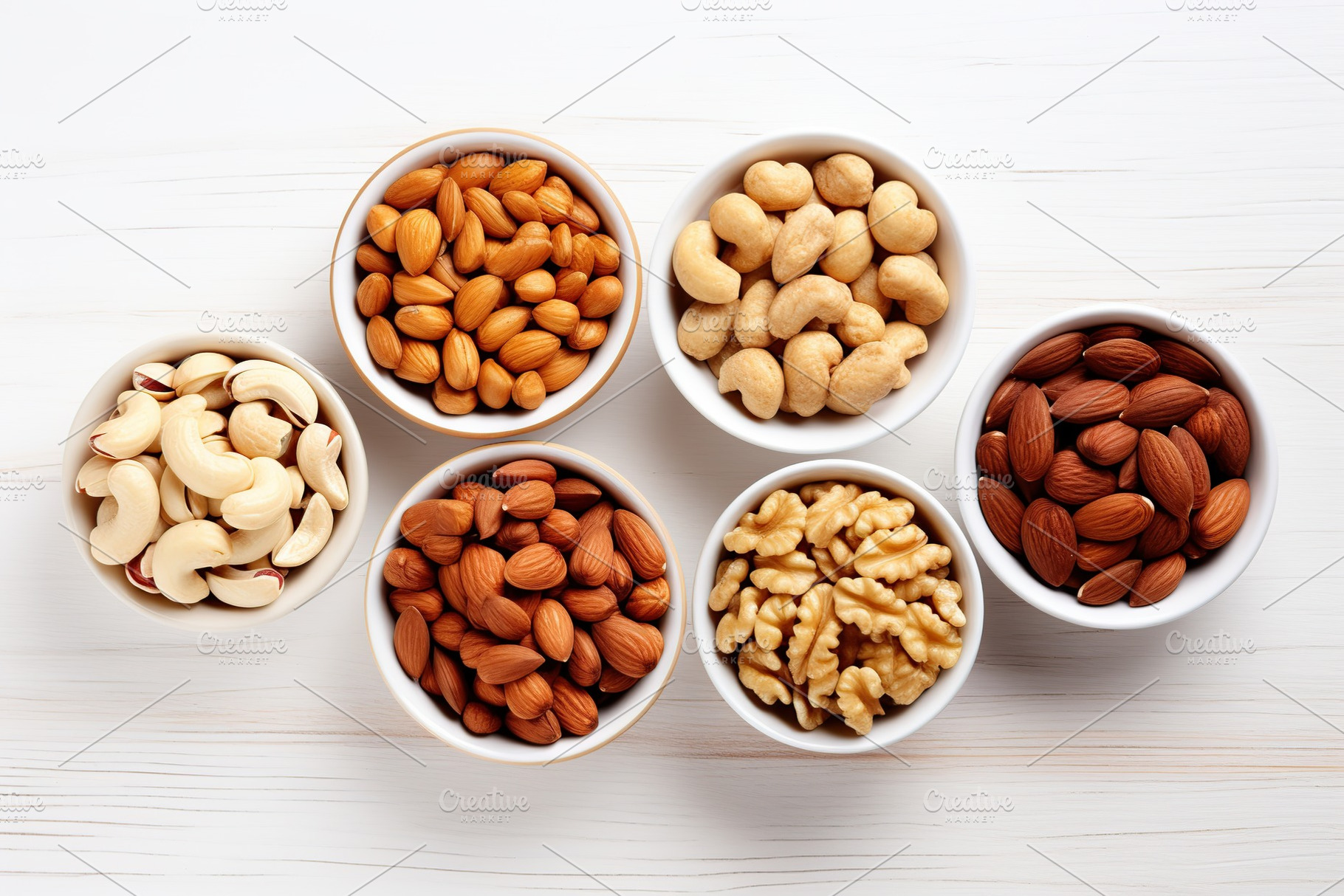 Bowls of hazelnut, cashew and almonds butter on wooden background, a Food & Drink Photo by AlyaAnd