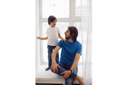 father in a blue T-shirt and a son, a Person Photo by SaulichPhoto