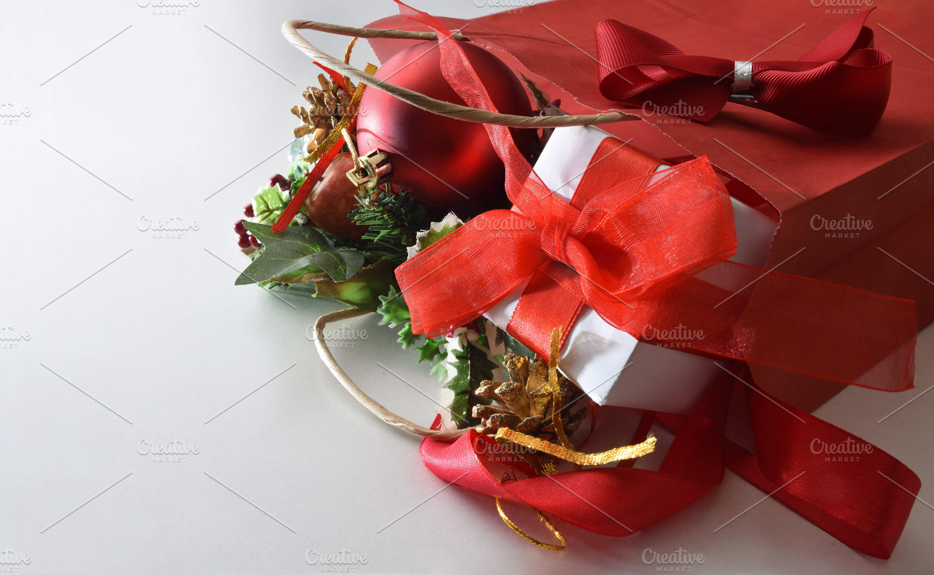 Shopping bag full of gifts on white table elevated view, a Holiday Photo by Davizro's Market