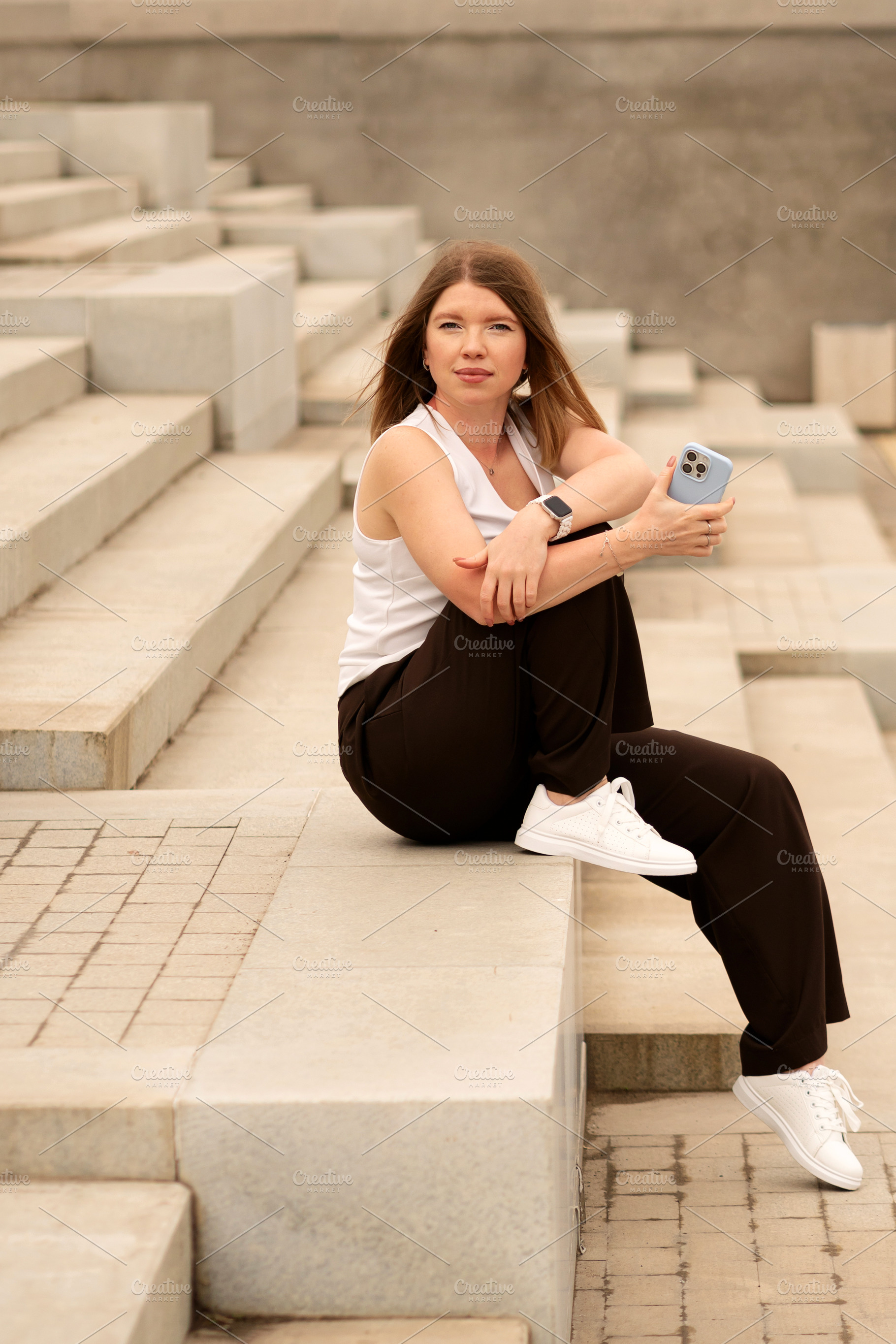 Young woman sitting on stairs, a Person Photo by Elena Vagengeim