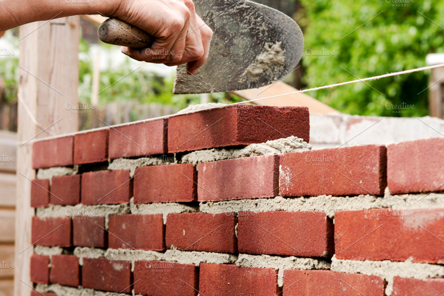 Bricklayer with trowel and cement