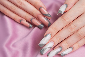 Woman showing trendy gray pink nail art manicure, a Beauty & Fashion Photo by Olena Rudo