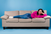Beautiful happy young black woman in casual wear lying on sofa and smiling at c, a Photo by Prostock-Studio (Thumbnail 1 of 2)