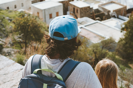 Father and daughter sightseeing Lindos city in Greece white houses aerial view, a Person Photo by e v e r s t