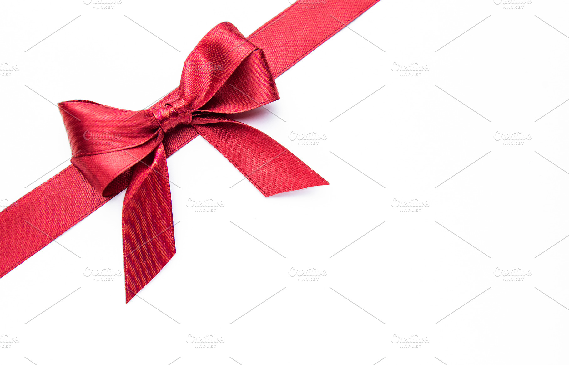 Red ribbon and bow creating a festive design, a Holiday Photo by Olena Rudo