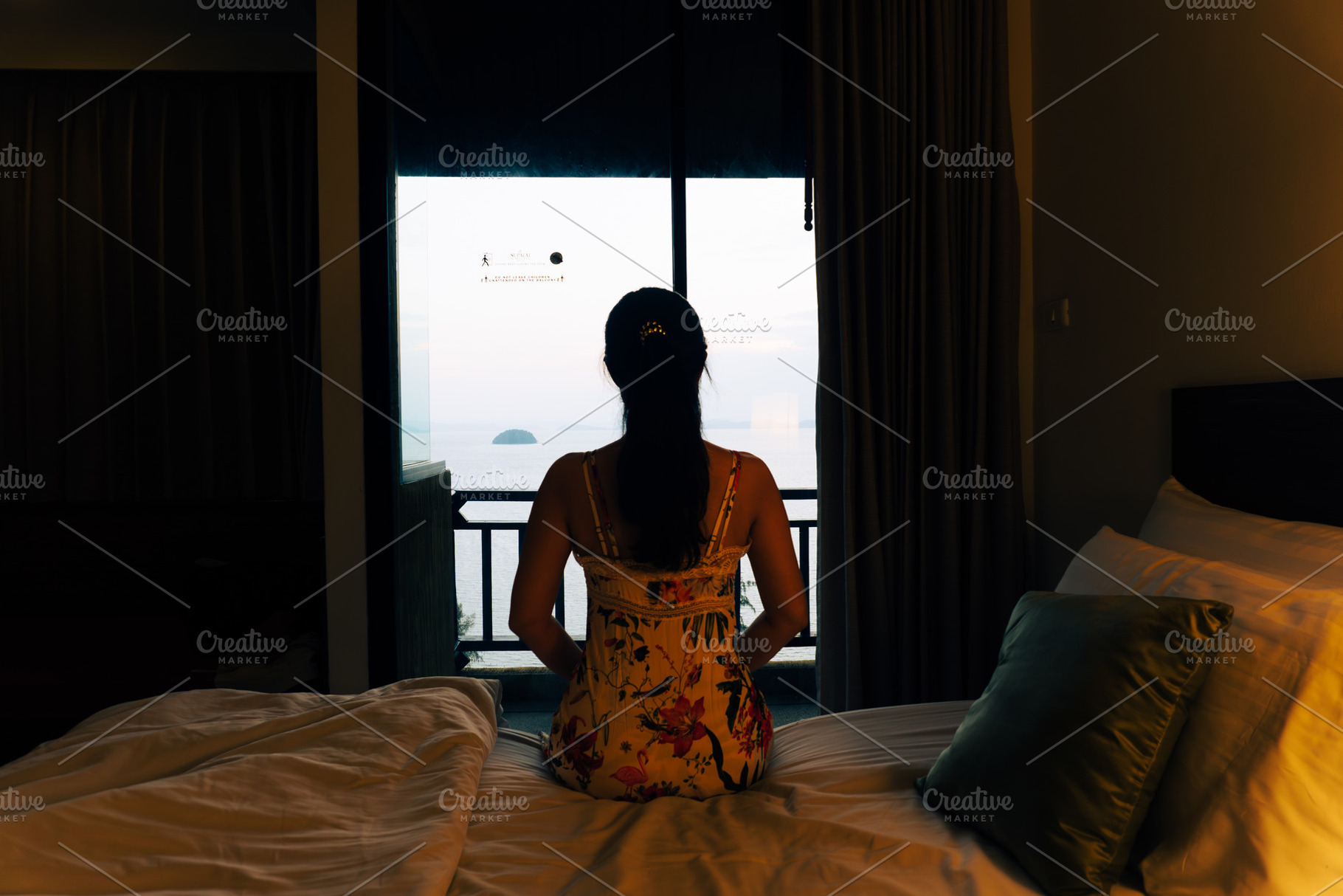 Young woman in a bedroom looking out, a Person Photo by AMMi