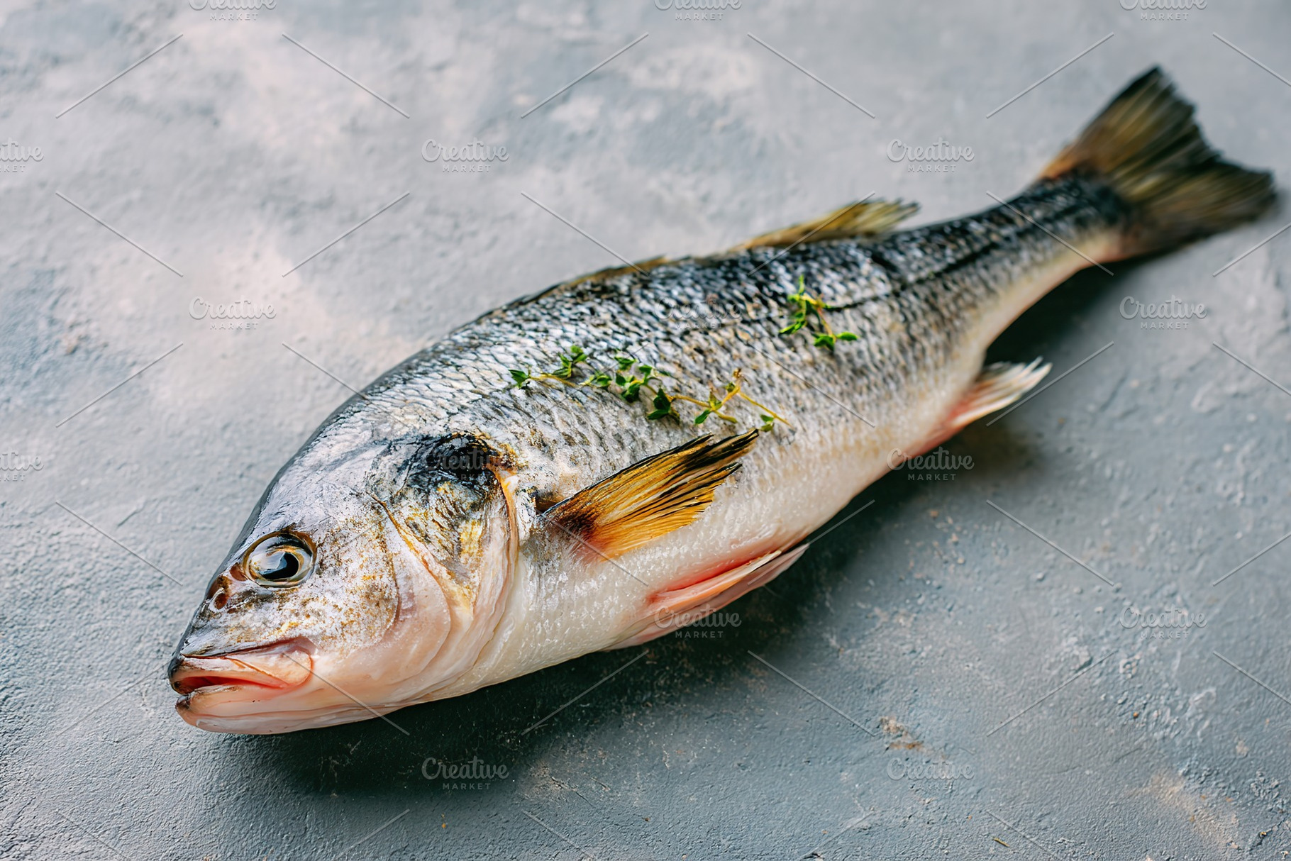 Fresh fish ready for preparation in the kitchen with herbs and spices nearby, a Food & Drink Photo by AlyaAnd