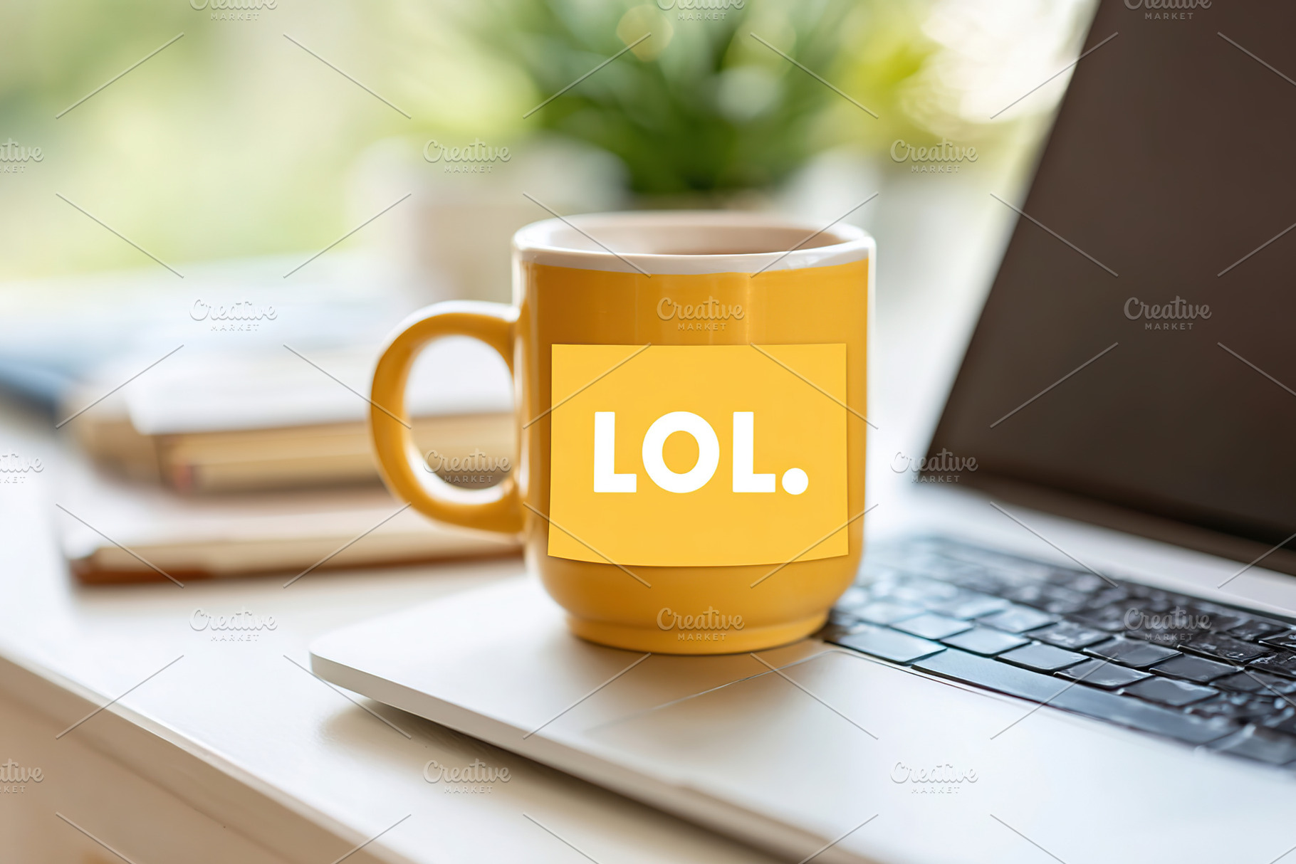 Laptop with broken M key and yellow mug displaying LOL sticker on a desk, a Photo by AlyaAnd