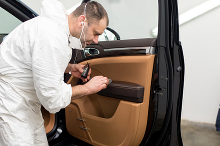 Man on a car wash polishing car with