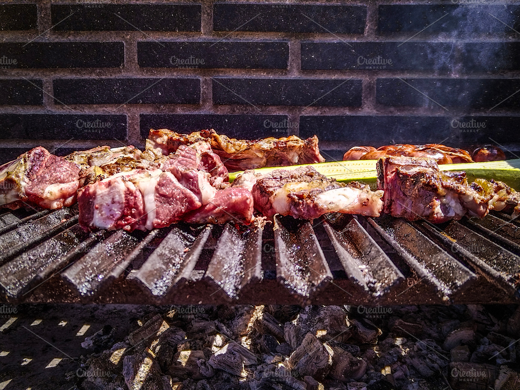 Meat skewers grilling on barbecue with smoke rising, a Food & Drink Photo by DanFLCreativo