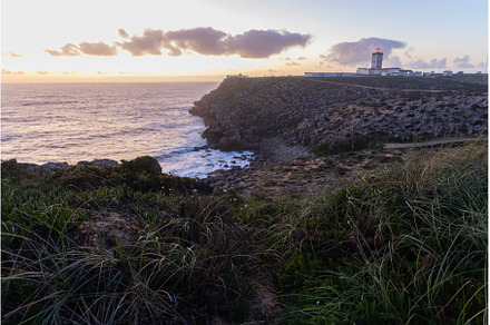 A lighthouse on an island on a hill, a Nature Photo by Barcelona_dreams