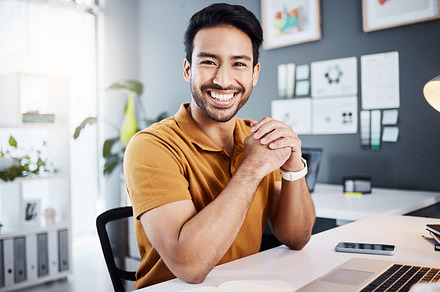 Smile, confidence and portrait of a man in the office while working on a business project with a laptop. Happy, success and professional male corporate employee planning a company report in workplace, a Photo by Peopleimages.com