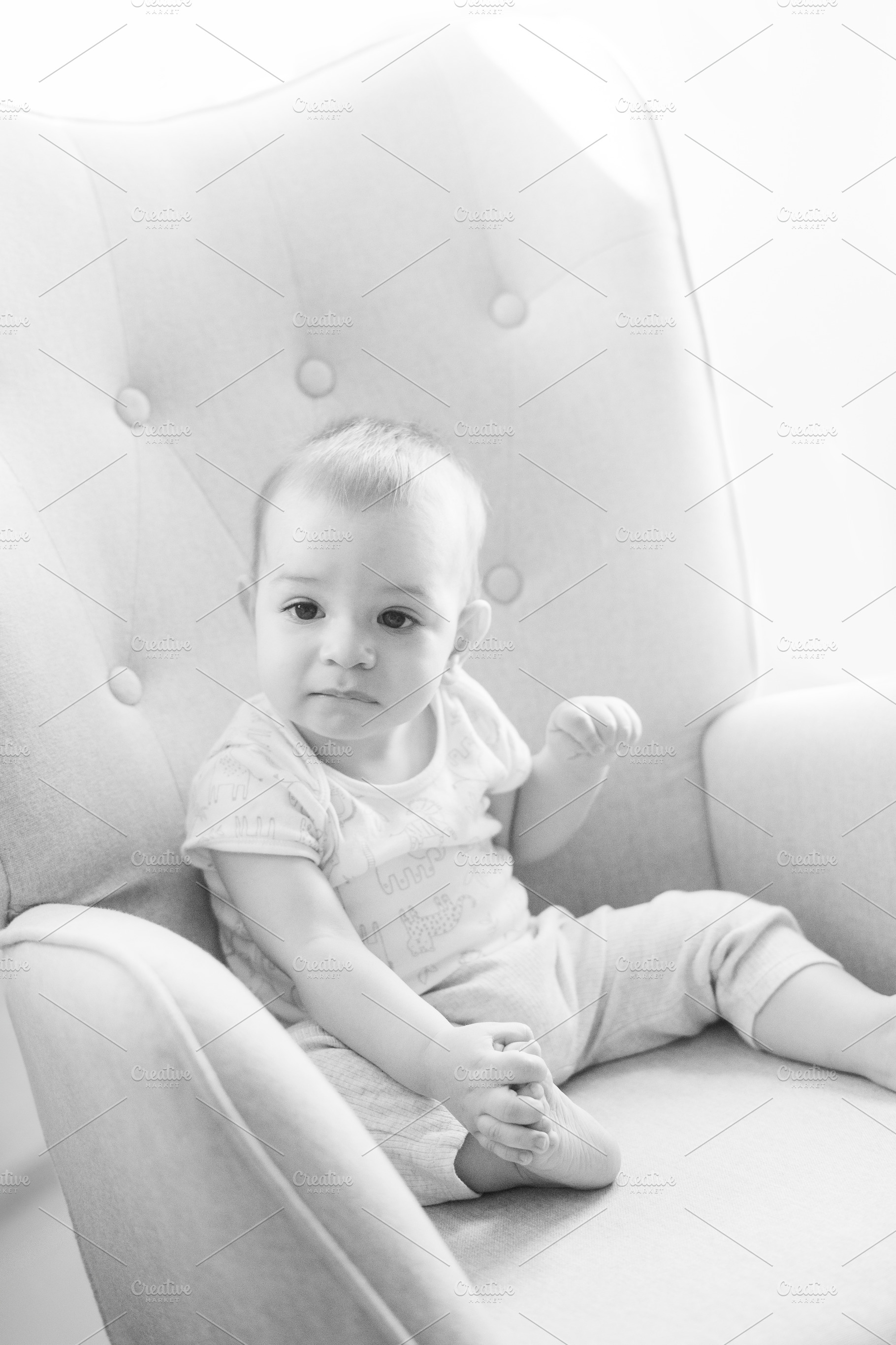 Portrait of a nine month old baby sitting in a rocking chair, a Person Photo by rubenchase