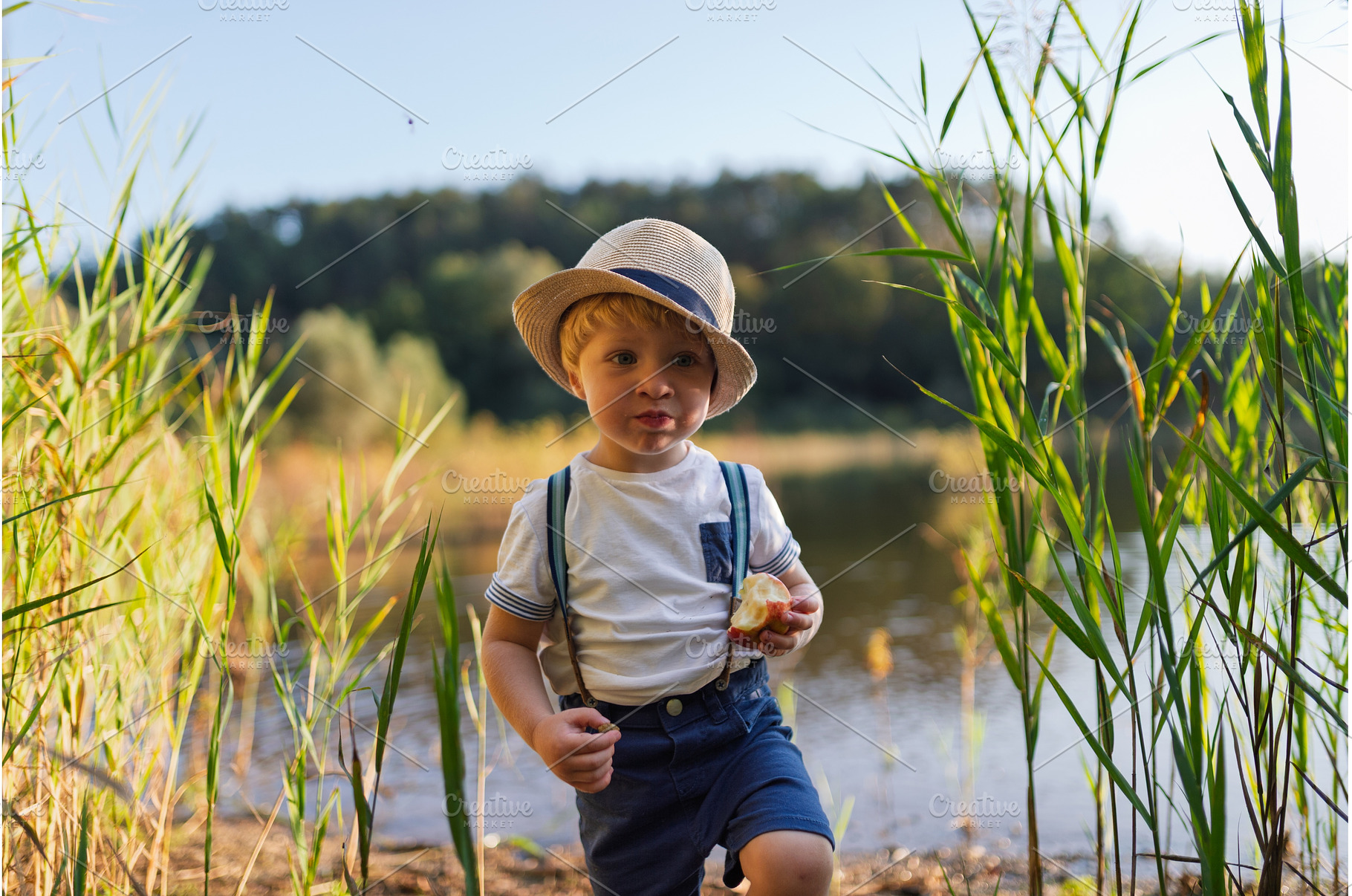 Toddler walking through lake, a Person Photo by HalfPoint