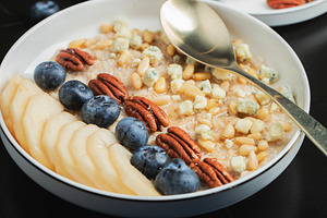 Oatmeal. Bowl of oatmeal porridge with blackberry, bananas and chia seeds on gr, a Food & Drink Photo by Budarinphoto