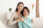 Happy mature Asian woman and her adult daughter hugging and smiling at camera,, a Photo by Prostock-Studio (Thumbnail 1 of 2)