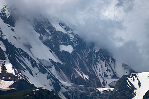 Snowy rocky mountain ridge shrouded in dense fog and clouds in G, a Photo by Pictures for you!!!!!!!!!