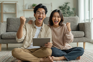 Happy couple celebrating success on, a Photo by Pixeness Studio