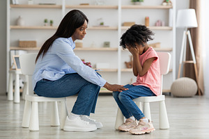 Distressed black kid crying at psychotherapy session, a Photo by Prostock-Studio