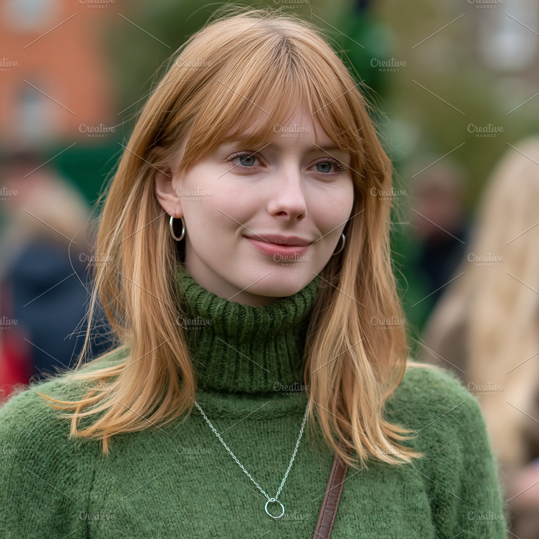 Young woman with strawberry blonde hair and bangs wearing a gree, a Person Photo by Studio ANNA
