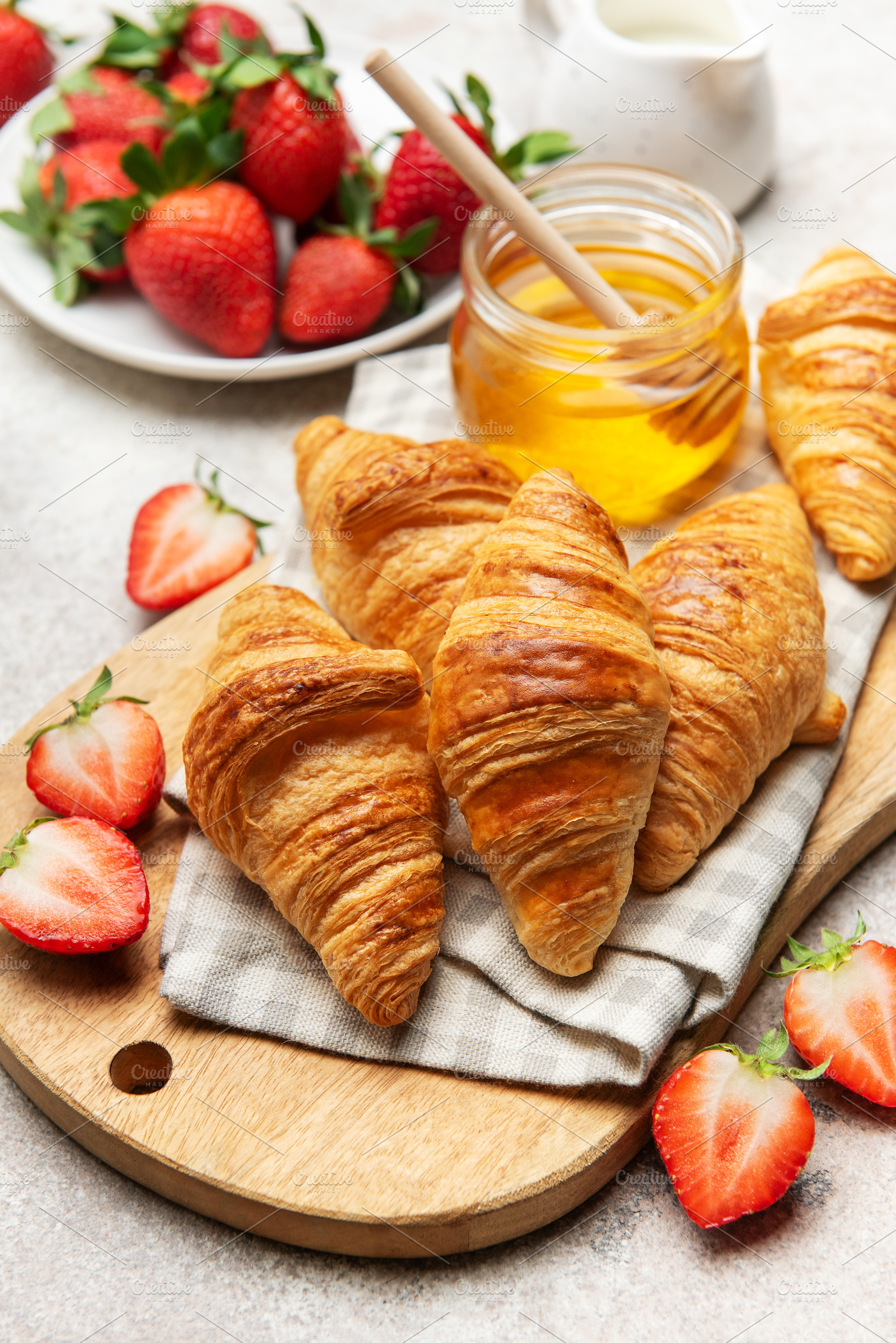 Delicious french croissants with fresh strawberries and honey fo, a Food & Drink Photo by Olena Rudo