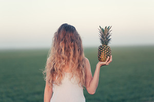 Portrait of woman with pineapple