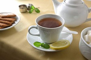 Tea and white ceramic containers on a table with tablecloth, a Food & Drink Photo by Davizro's Market