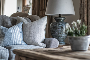 Cozy living room interior with cushions and lamp, creating a comfortable and re, an Architecture Photo by Studio ANNA