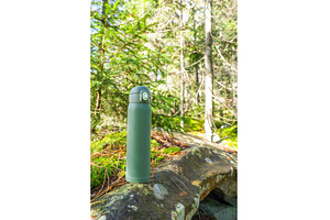 Green thermos on the stone. Thermal, a Food & Drink Photo by Stockphoto by vzwer