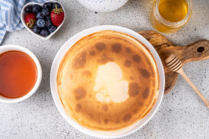 Homemade french tiny pancakes, crepes with berries and honey, a Food & Drink Photo by Rimma