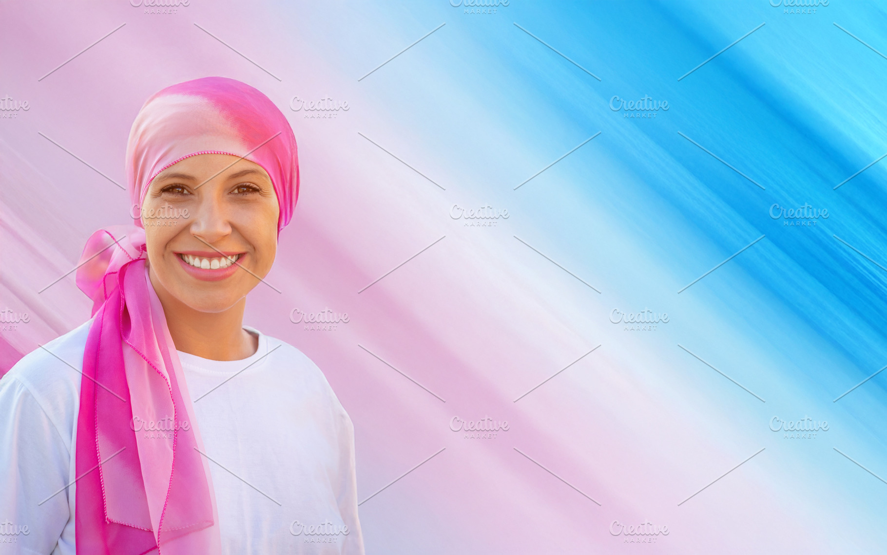 Smiling Woman Wearing Pink Headscarf for Cancer Awareness with S, a Person Photo by José Manuel Gelpi